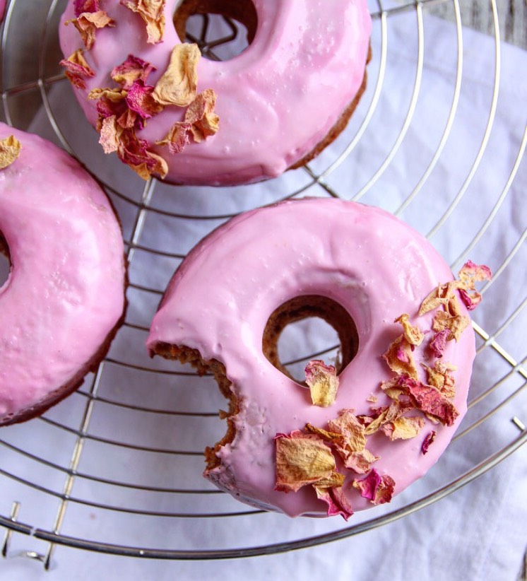 Healthy Baked Vegan Cinnamon Donuts with pink glaze.
