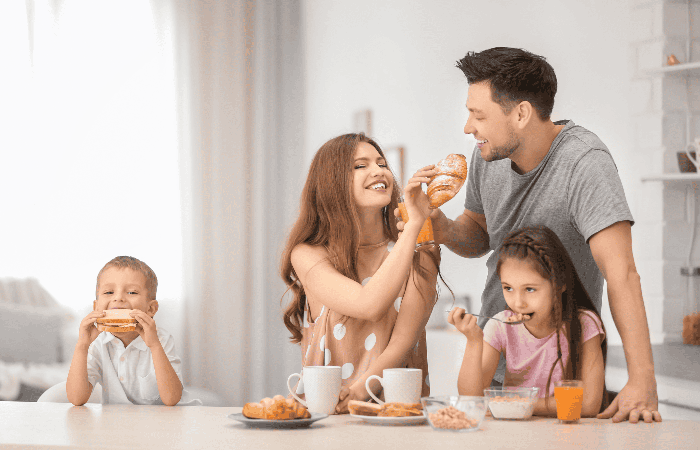 young family enjoying a meal together as some members of the family are vegan and others are meat eaters