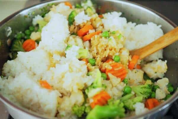 Stirring-white-rice-with-frozen-vegetables Easy Cheap Fried Rice Recipe _